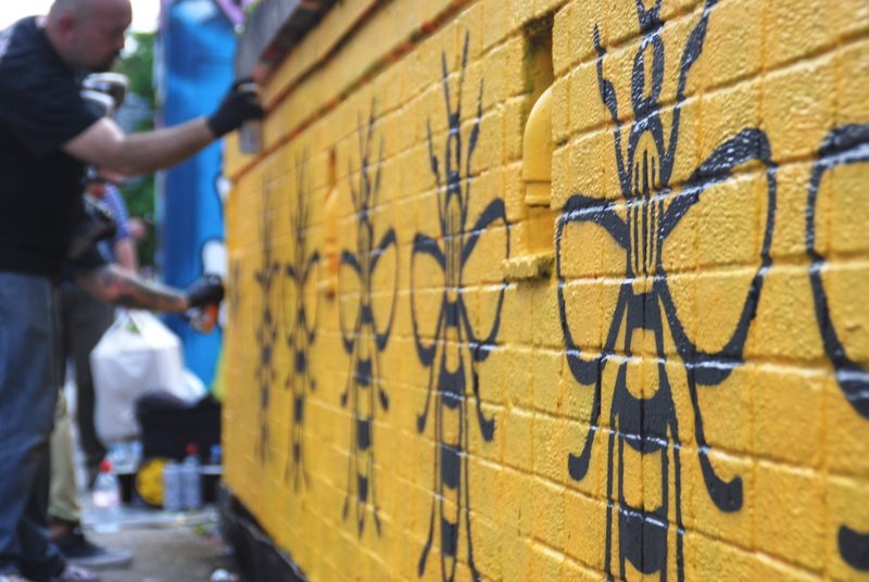 focus on foreground, selective focus, yellow, standing, 4K, day, in a row, street art, occupation, group of people, men, stencil, adult, indoors, repetition