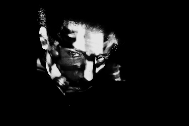 one person, copy space, accessories, close-up, human, black background, photography, dark, performer, young adult, prison, beard, portrait, human body part