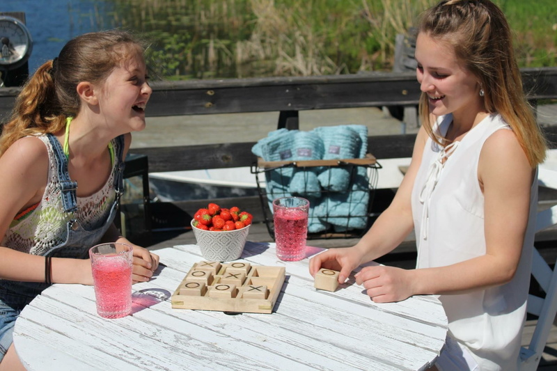 two people, Summer Vacation, females, table, toe, casual clothing, Siblings, tac, hairstyle, two, leisure activity, food, game, winner, adults only, adult