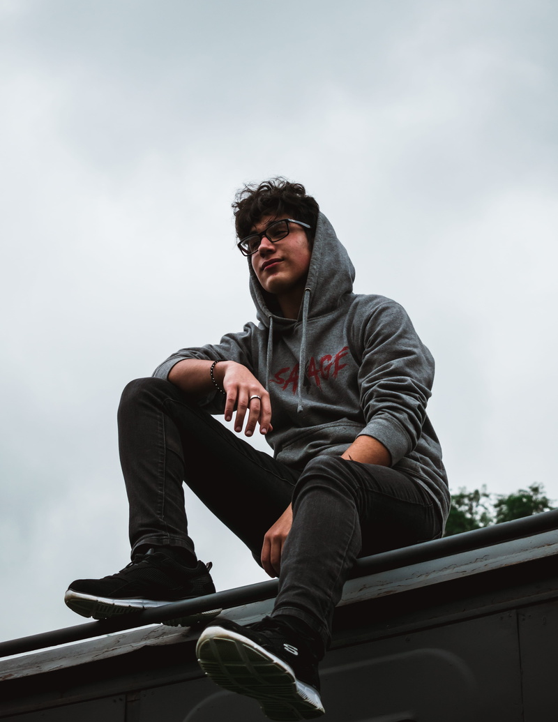 cloud - sky, sky, young men, young adult, glasses, casual clothing, real people, men, savage, day, one person, nairobi, sitting, 5K, looking, outdoors