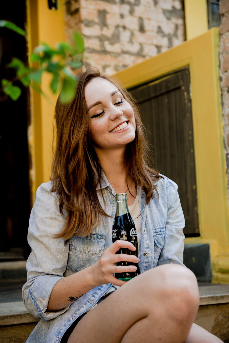 young adult, drink, lifestyles, casual clothing, long hair, closed eyes, outdoors, 2K, jeans jacket, three quarter length, hair, drinking, beautiful woman