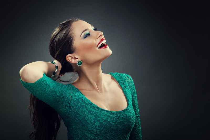 mouth, lipstick, hair, face, makeup, fashion, teal, neck, hairstyle, hand, tail, smile, top, young women, black background, adult, one person, model, waist up