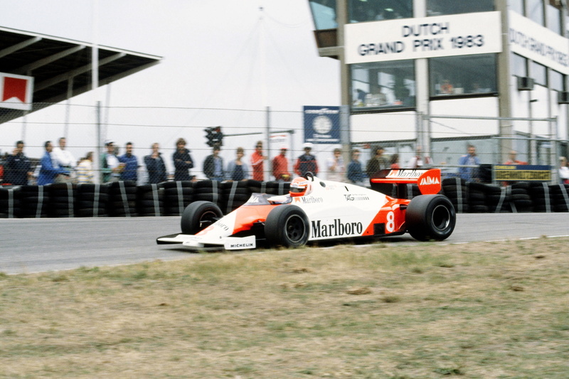 text, real people, car, communication, architecture, day, race, city, mp4-1e, building exterior, group of people, racing, formula, 1983, f-1, mclaren, outdoors