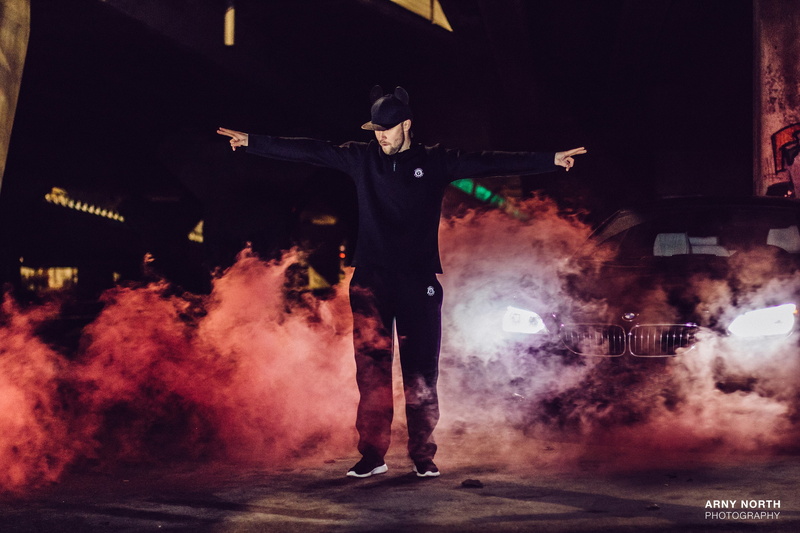 smoke - physical structure, arts culture and entertainment, BMW 650i, arms raised, illuminated, young men, stage - performance space, stage, night, standing
