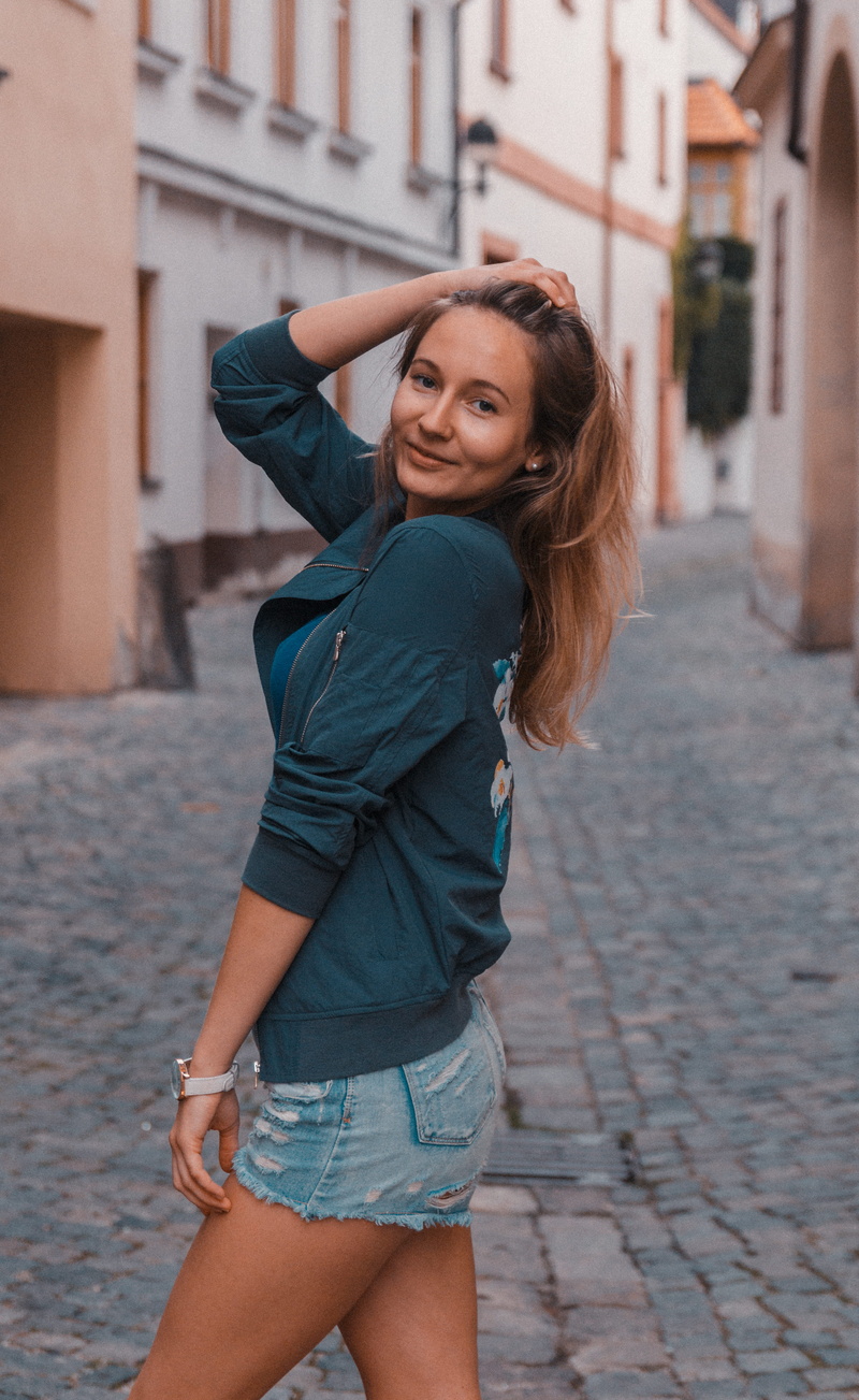 beautiful woman, building exterior, grey, dress, girl, focus on foreground, miniskirt, right, looking at camera, jeans, one person, young women, portrait
