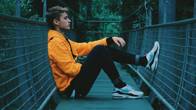 sport, dance pose, young men, sitting, real people, clothing, men, yellow, nature, sit, hanging, casual clothing, blur, architecture, looking, human, man