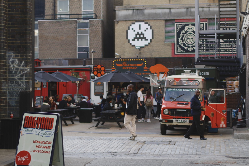 person, human, hospital, walking, city street, ambulance, women, real people, building exterior, bus, transportation, man, storefront, group of people