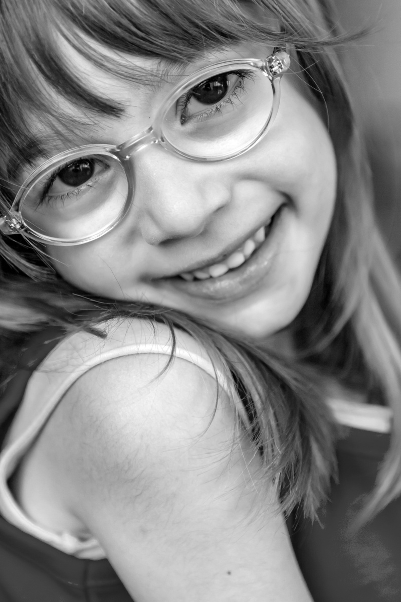 black and white, looking at camera, girl, indoors, front view, blonde, lifestyles, female, smiling, hulki okan tabak, one person, content, eyeglasses, hairstyle