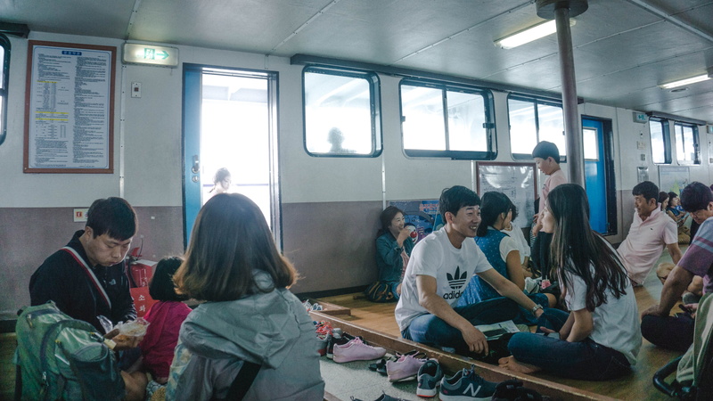 asians, crowd, lifestyles, women, window, sitting, ship, real people, jeju, men, south korea, rail transportation, casual clothing, public transportation