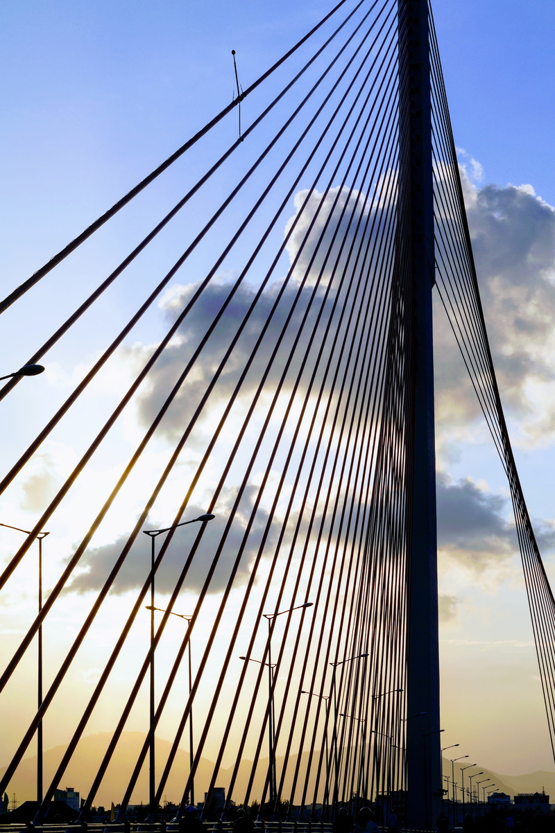 steel cable, rope bridge, bridge - man made structure, built structure, sunny, sailboat, cloud - sky, bridge, low angle view, vietnam, cable, sunset, transportation