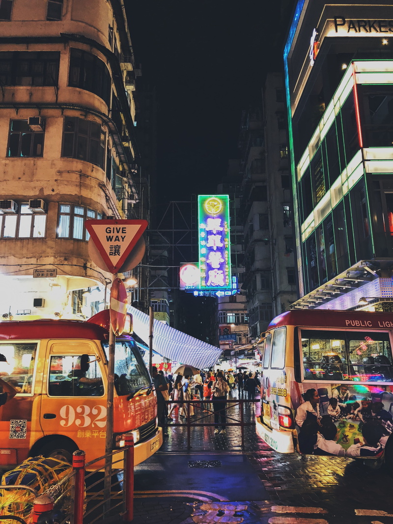 office building exterior, motor vehicle, public transportation, hong kong, city life, incidental people, night market, transportation, communication, built structure