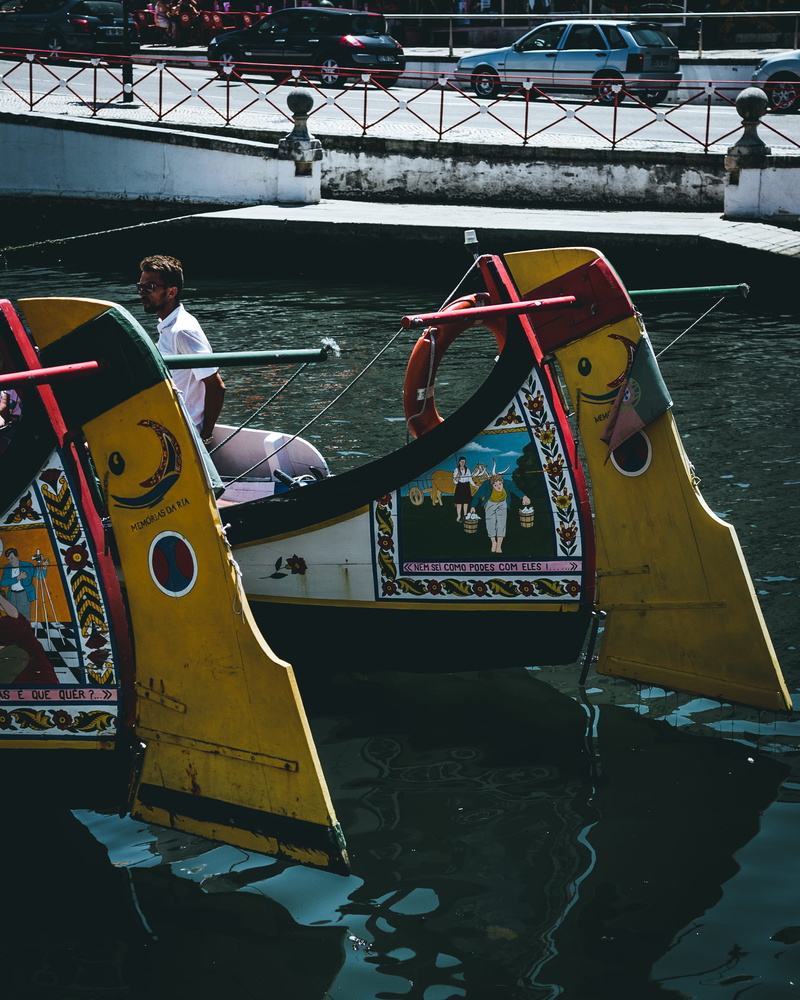 amusement park, automobile, nautical vessel, collared, person, leisure activity, amusement park ride, transportation, dock, yellow, tire, standing, built structure
