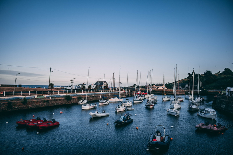mode of transportation, boat, human, passenger craft, yacht, outdoors, sea, waterfront, marina, port, water, nature, sky, ferry, moored, sailboat, tower