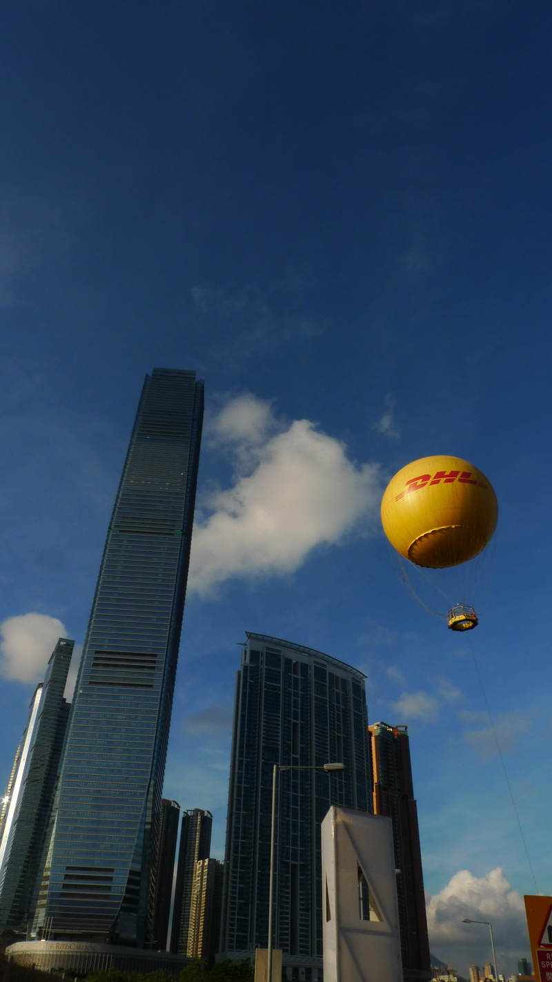 hong kong, low angle view, building, cloud - sky, sky, skyscraper, office building exterior, flying, building exterior, city, balloon, nature, tall - high