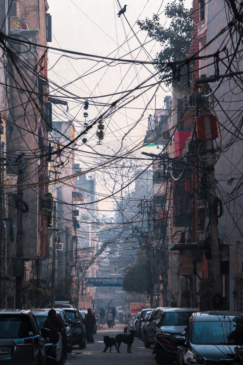 built structure, roadside, tree, day, building, outdoors, power line, tower, mode of transportation, land vehicle, daytime, building exterior, nature, city life