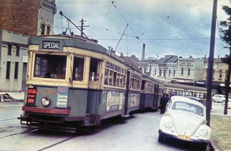 mode of transportation, buidling, tram, land vehicle, window, street, building exterior, rail transportation, bus, no people, 720P, railroad track, motor vehicle