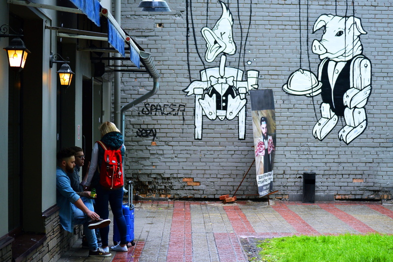 mural, listener, service industry, city, building exterior, full length, real people, caucasian, lifestyles, female, sitting, child, service, brick, break