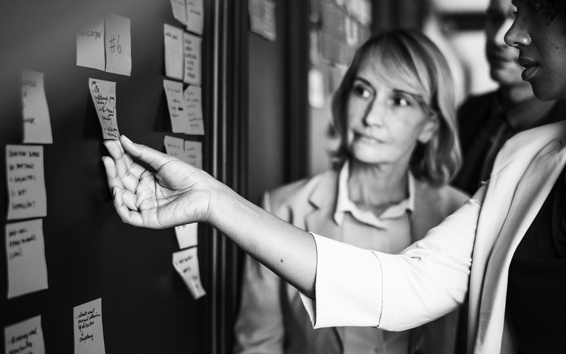 people, teamwork, real people, focus on foreground, sticky note, post, to do, reminder, technology, black and white, young adult, young women, indoors