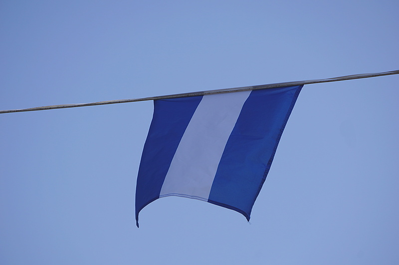 low angle view, white, freedom, stripe, flag, no people, flying, sky, day, outdoors, blue, transportation, hung, sunny, copy space, clear sky, nature, clean