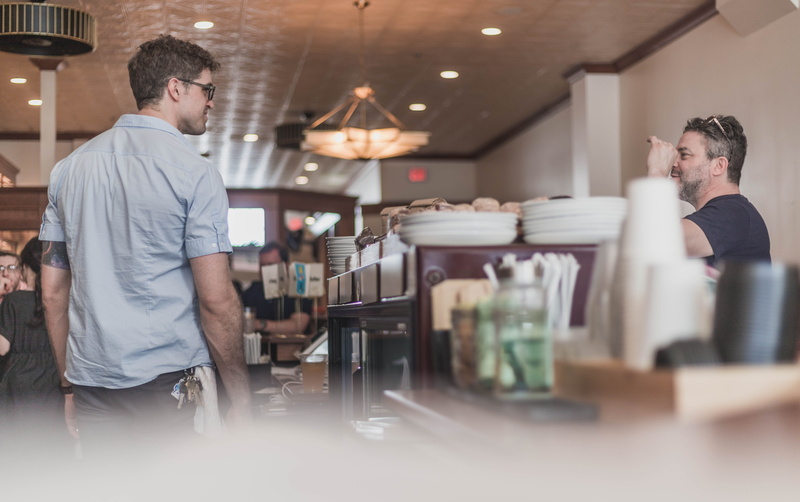 coworker, indoors, cafe, home decor, working, restaurant, service, meal, preparation, entrepreneur, occupation, people, adult, apparel, serving food and drinks