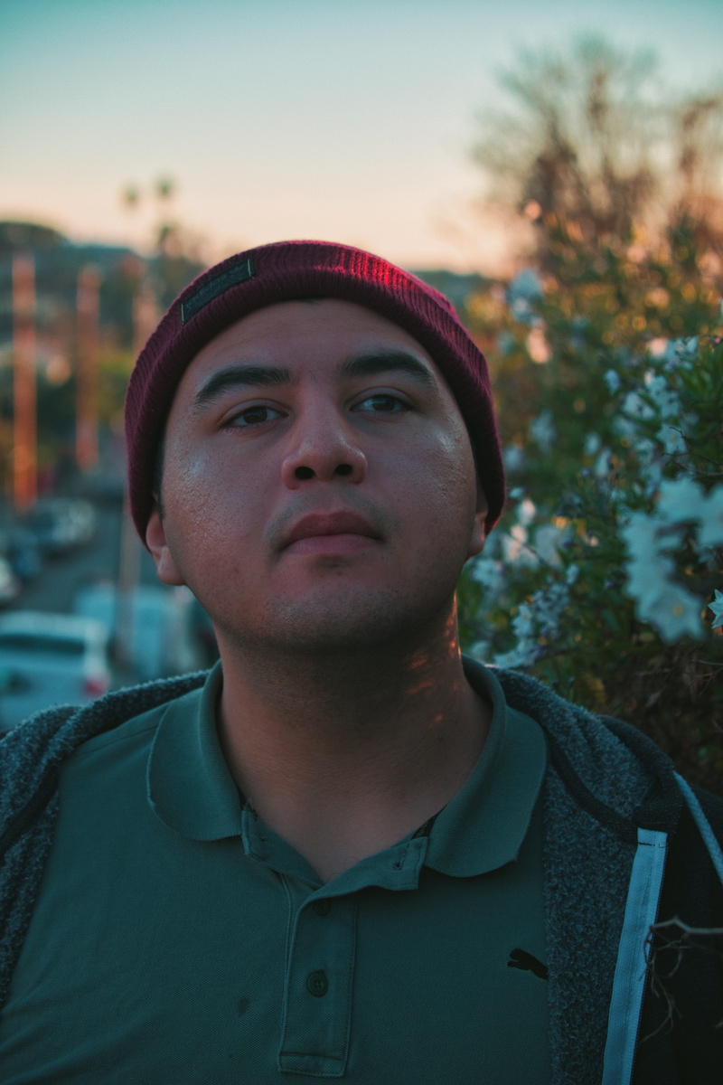 golden, urban, person, focus on foreground, los angeles, hat, lifestyles, plant, portraiture, collared, front view, men, young men, hour, looking away