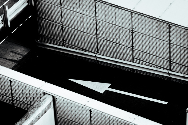 architecture, black and white, parking garage, nature, high angle view, sign, solar panels, day, building exterior, building, arrow, 5K, symbol, text