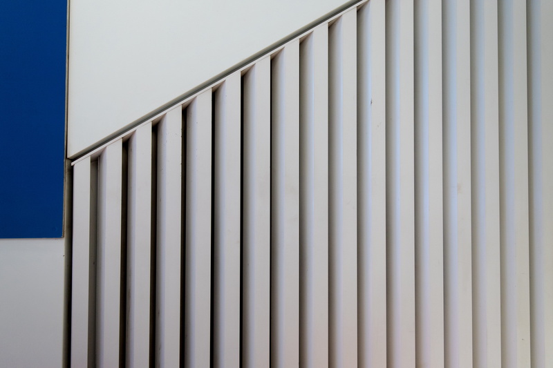 5K, banister, parachute, sunlight, white color, fence, day, railing, metal, no people, corrugated, blanket, wall, built structure, protection, prison