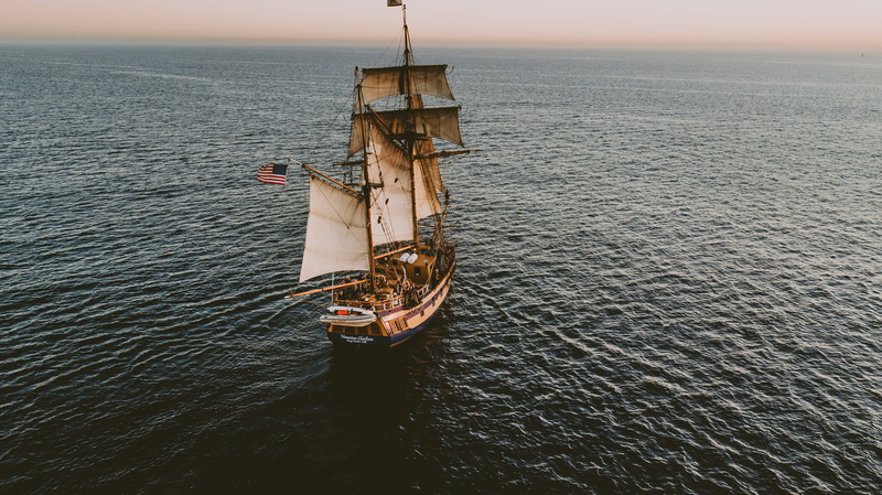 nature, waterfront, nautical vessel, white, transportation, explore, beach, outdoors, american flag, day, voyage, sky, no people, high angle view, flag