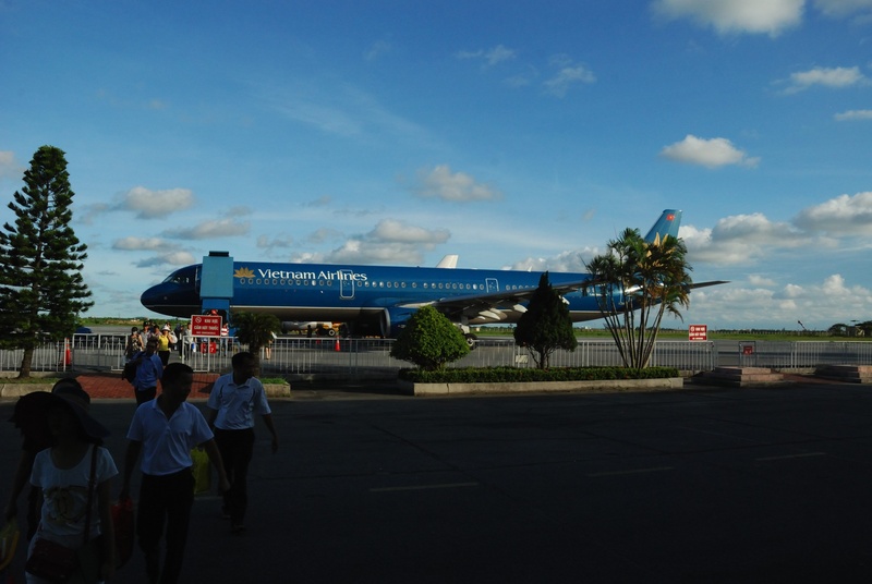 people, crowd, cloud - sky, building exterior, aeroplane, city, architecture, women, airplane, catbi airport, built structure, landed, outdoors, blue, real people