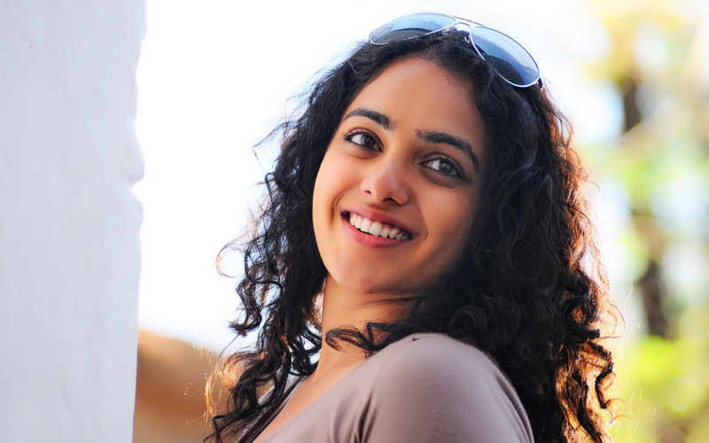 leisure activity, one person, young adult, beauty, black hair, hair, hairstyle, headshot, looking at camera, human face, curly hair, adult, girls, nithya menon