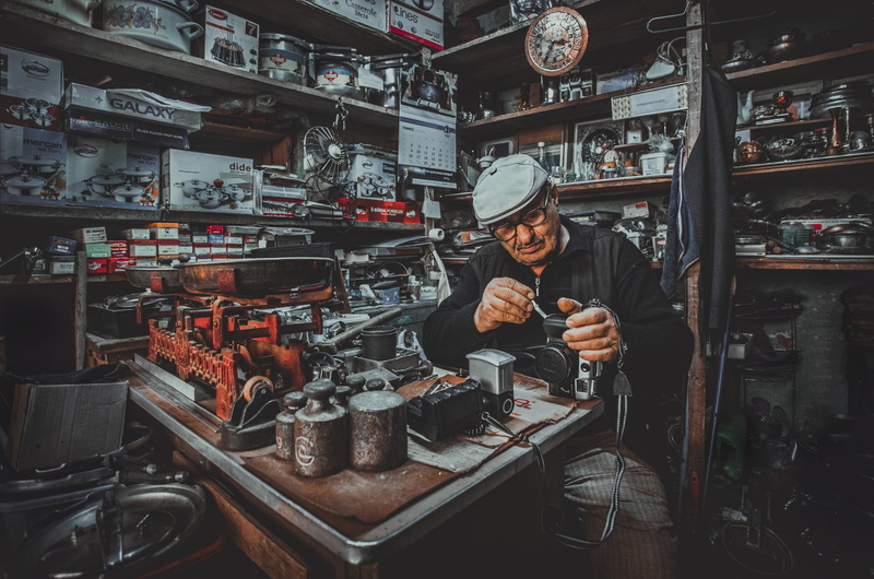 women, nostalgic photo karabulut, indoors, photographer, repairman, small business, business, standing, 2K, ragman, historic, retail display, front view