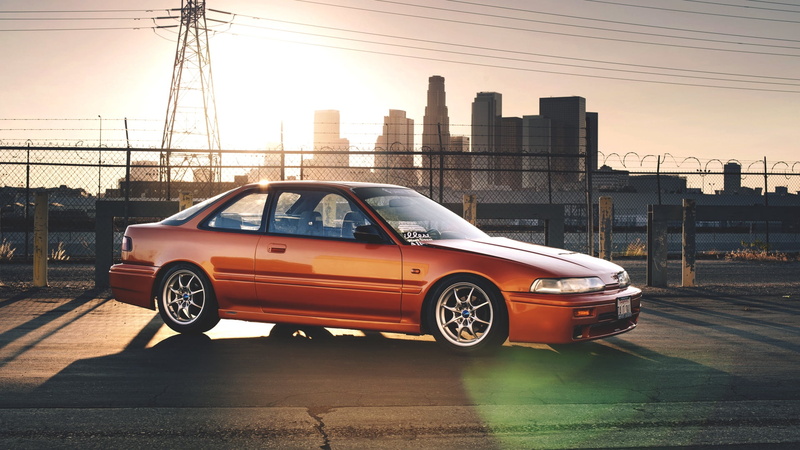 orange, outdoors, skyscraper, sedan, headlight, cityscape, travel, building exterior, built structure, city Life, driving, sky, speed, traffic, prelude