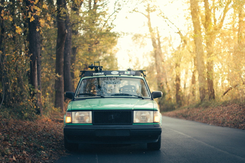 outdoors, motor vehicle, no people, trunk, dark, old school, forest, car, mode of transportation, travel, retro styled, tree, autumn, nature, surrounded