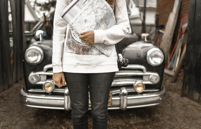 steering wheel, focus on foreground, shoe, land vehicle, faceless, map, black, person, real people, one person, hand, women, front, adventure, outdoor