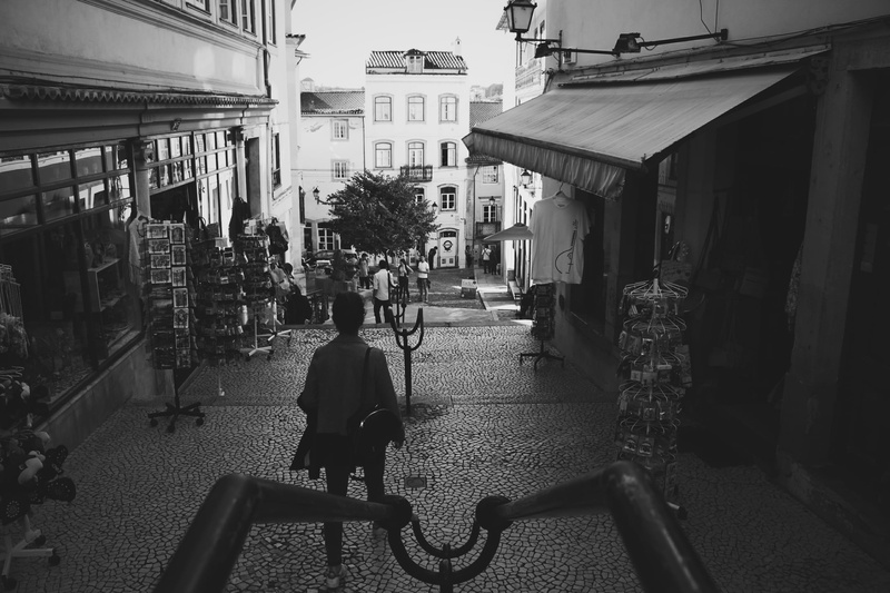 2K, building exterior, bw, people, urban, one person, full length, direction, mode of transportation, lifestyles, street, real people, rear view, built structure