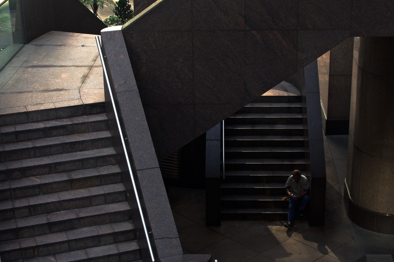 one person, central, railing, architecture, staircase, women, full length, leisure activity, outdoors, people, real people, sunlight, steps and staircases