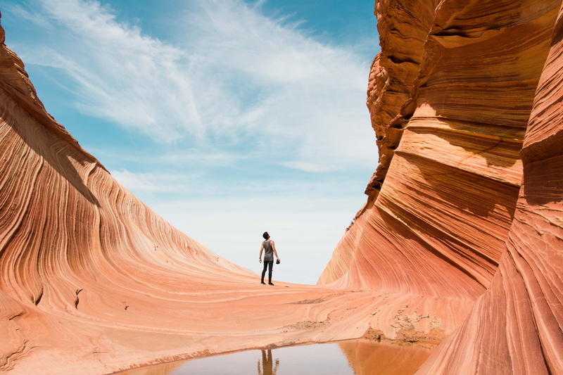 cloud, outdoors, real people, wanderlust, antelope, sunlight, beauty in nature, wonder, scenics - nature, rock, travel, curve, red, daytime, man, puddle