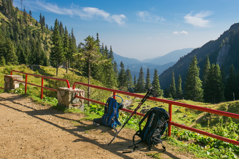 scenics - nature, red, land, black, vacations, men, mountain, daytime, fence, valley, blue, backpacks, sunlight, travel, growth, mountain range, road, railing