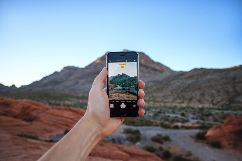 human hand, mountain range, landscape, desert, 5K, human body part, portable information device, hand, holding, taking a picture, people, sky, technology