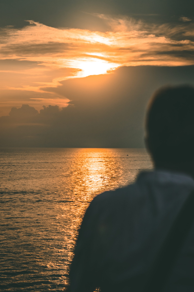 sea, one person, cloud - sky, tranquil scene, leisure activity, beauty in nature, coast, reflection, dramatic sky, rovinj, men, sunset, orange color, person