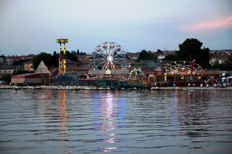city, funfair, sea, building exterior, travel destinations, traveling carnival, built structure, rollercoaster, istria, water, leisure activity, porec