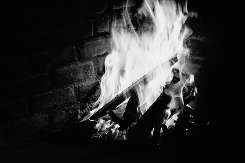 no people, night, wall, flame, resort, architecture, smoke - physical structure, wood - material, island, burning, bonfire, event, indoors, blurred motion