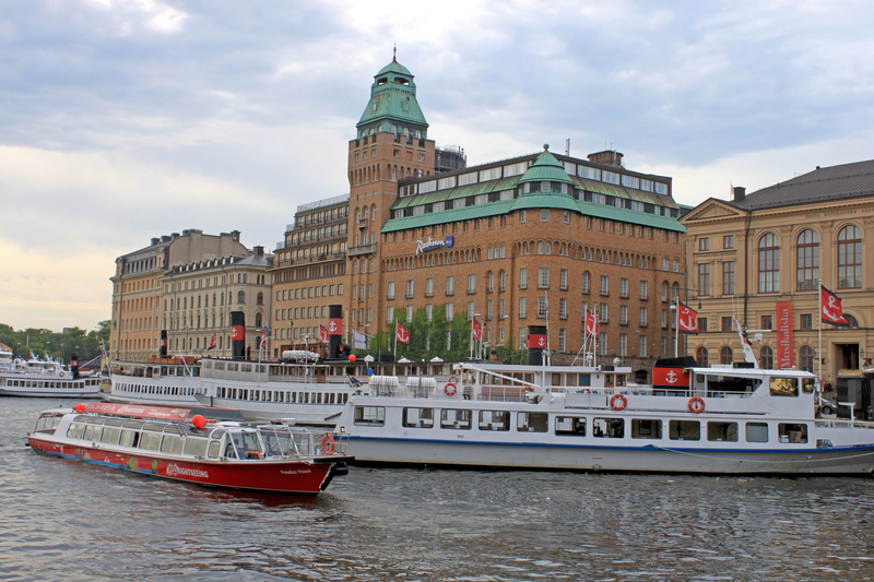 nautical vessel, sky, tower, tourist, canal, vacation, gamla stan, europe, european, architecture, mode of transportation, building exterior, the urban landscape