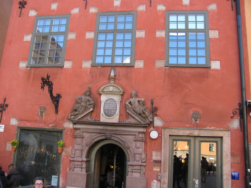 building exterior, women, clock, gamla stan stockholm, sweden, red, stockholm, built structure, incidental people, history, arch, door, building, outdoors