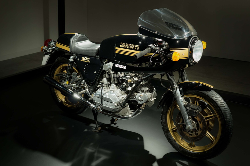 vehicle, bike, motorcycle, day, pavement, design, machine, stationary, indoors, close-up, transportation system, helmet, metal, headlight, engine, style