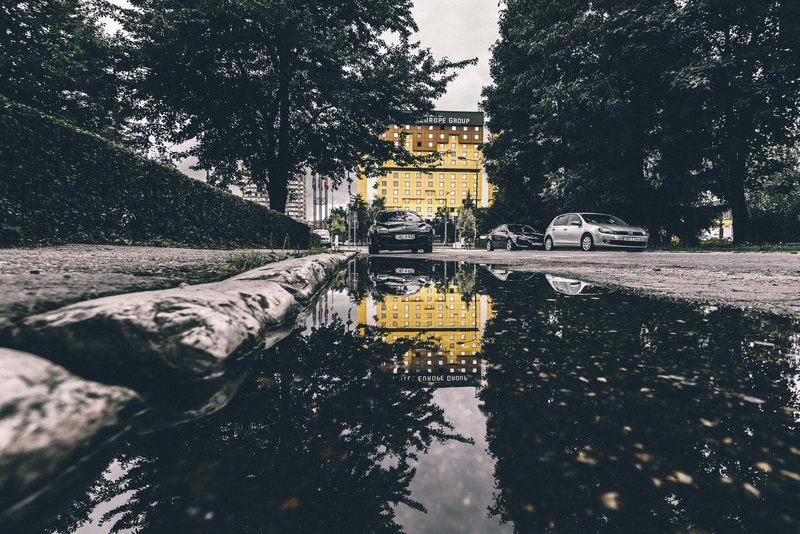 summer, high, sarajevo, tree, land vehicle, rise, puddle, daytime, rainy season, no people, sidewalk, hedge, cloudy, leaf, water, outdoors, beside, mode of transportation
