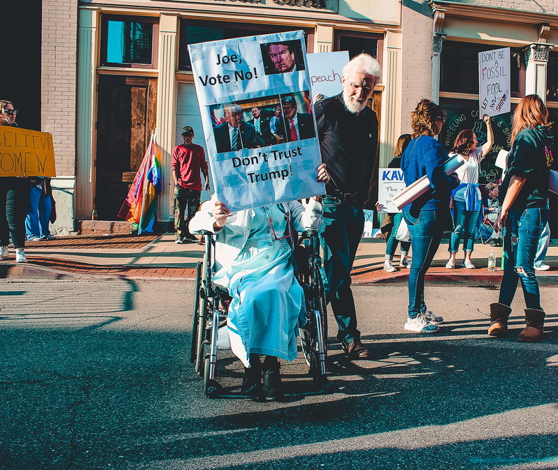 wheelchair, rally, medium group of people, walking, building exterior, group of people, woman, outdoors, protest, women, posters, day, group, real people
