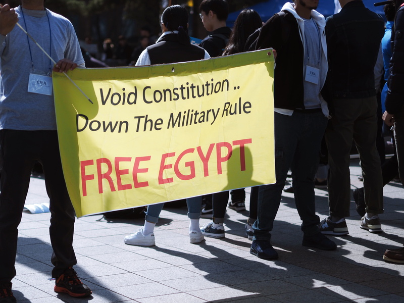overcoat, day, communication, crowd, real people, person, men, egypt, footwear, architecture, apparel, group of people, text, protest, human, western script