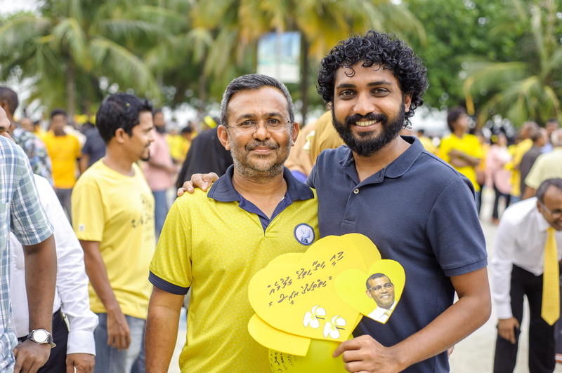 day, focus on foreground, front view, wear, mature adult, democracy, incidental people, people, road, looking at camera, happiness, mature men, gathering