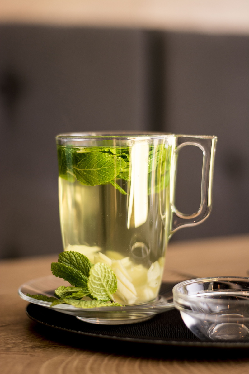 indoors, mint, leaf, table, tea cup, glass, mug, saucer, nutrition, household equipment, drink, drinking glass, herbal tea, 5K, food, close-up, tea - hot drink